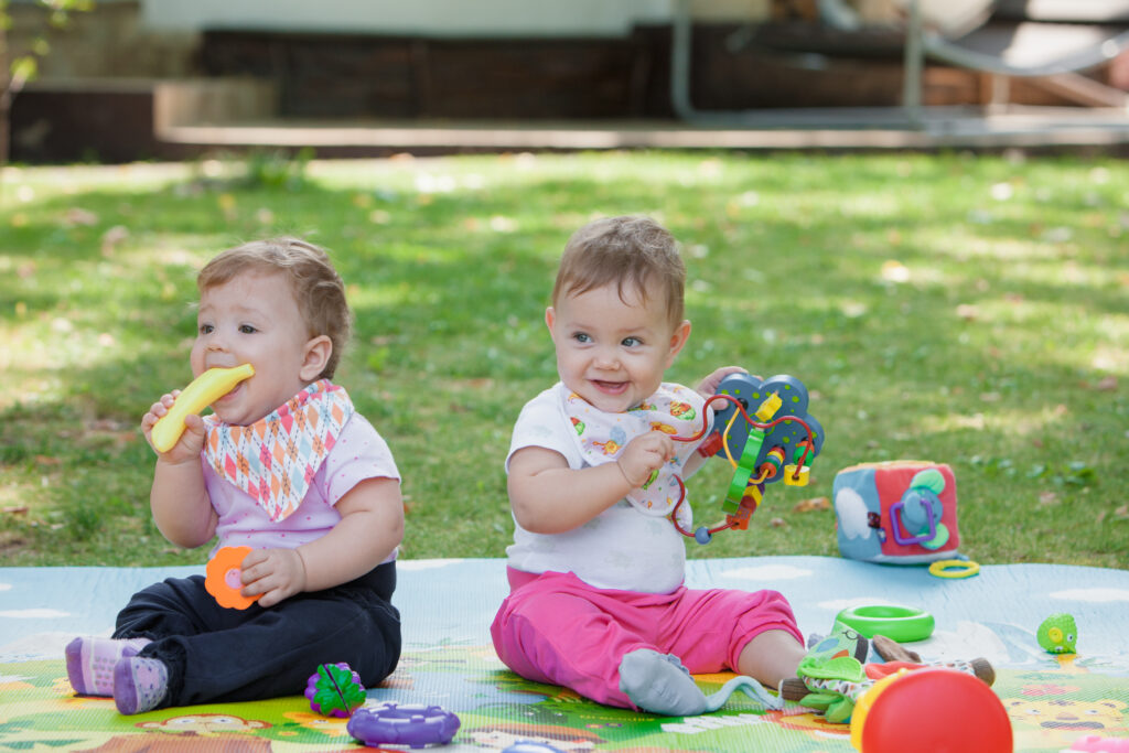 babys less than year old playing with toys