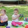 babys less than year old playing with toys scaled e1668612260467