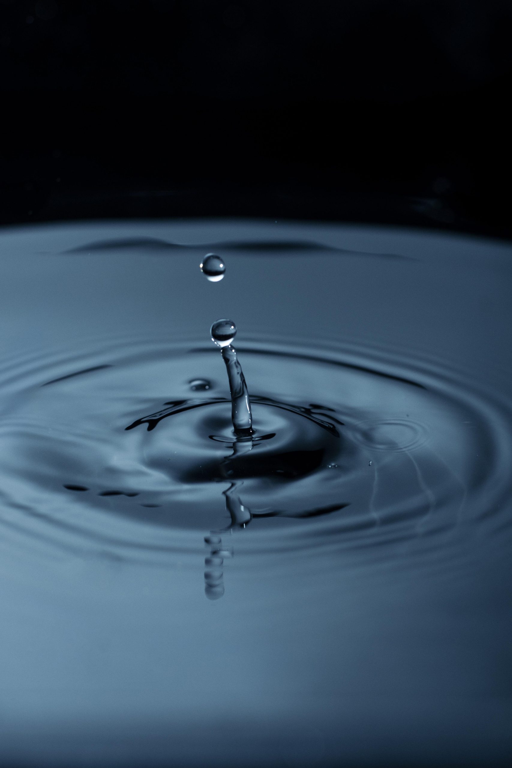 water droplets creating ripple liquid scaled